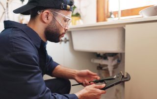 Licensed plumber performing gas line leak detection in Nogales kitchen